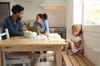 A family sitting together at the kitchen table